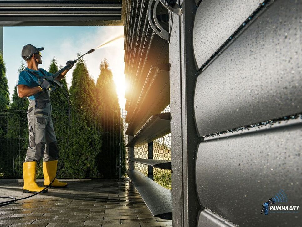 man pressure washing a Panama City home fence